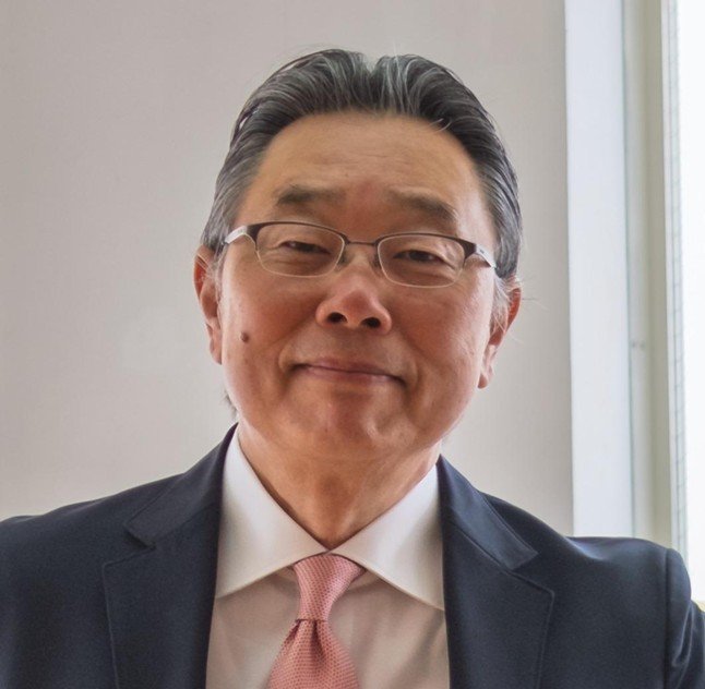 Hiroshige Sugihara in suit with pink tie